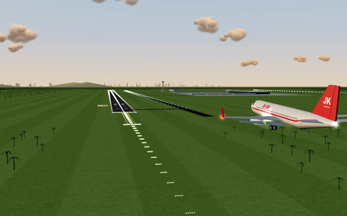 An original white and red twin-jet, JK Air, on final approach at sunset, with the runway lights ahead.